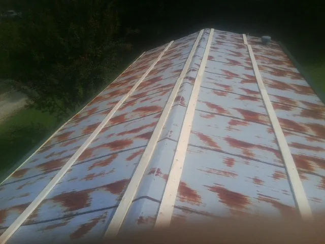 Rusted metal roof panels with new wood purlins before replacement — Storm Damage Roof Repair in Bahama by Roofing Brothers
